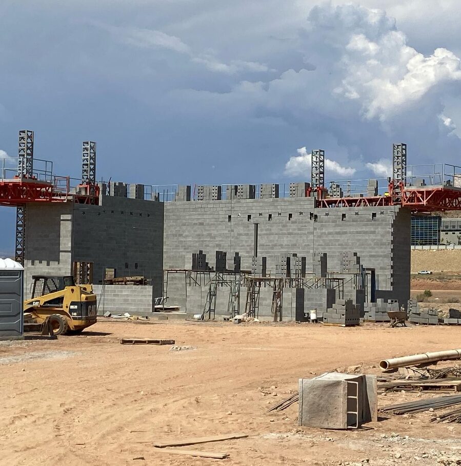 Masonry construction workers installing footers for a building foundation.