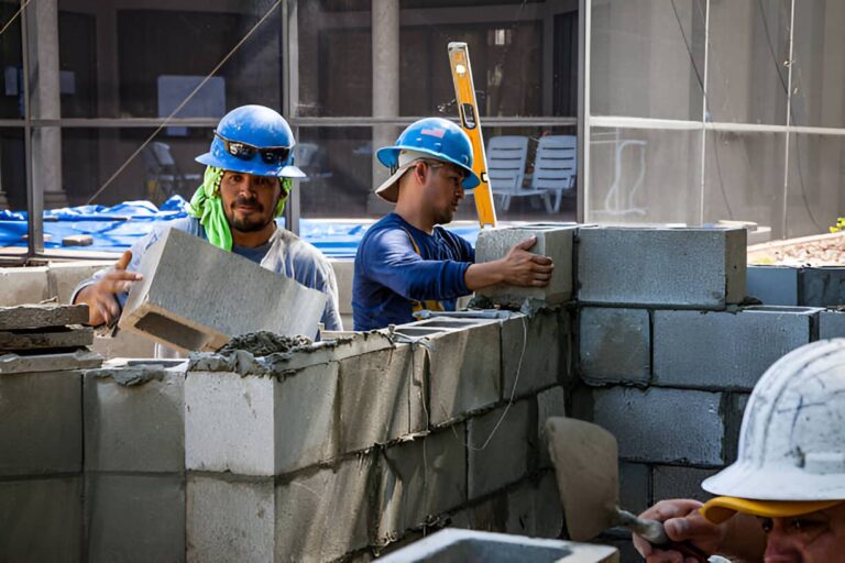 Professional mason building a concrete block wall in Colorado Springs