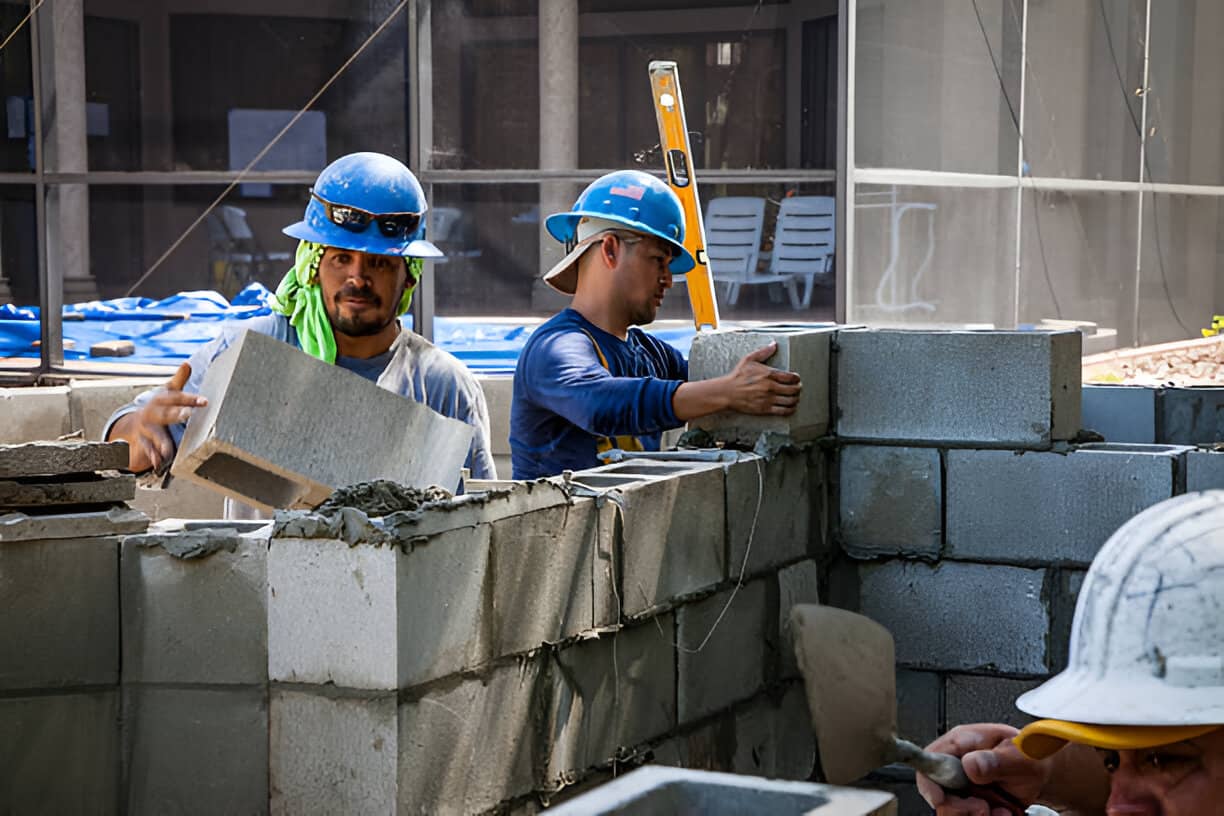 Professional mason building a concrete block wall in Colorado Springs