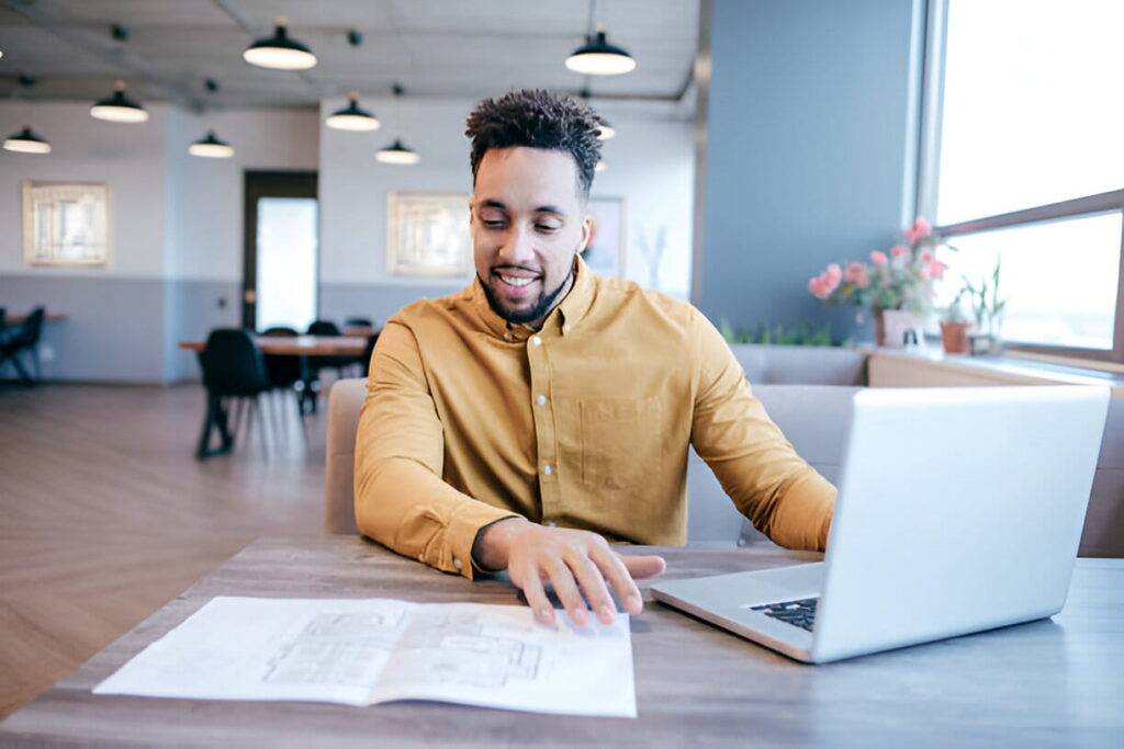 Toronto homeowner reviewing quotes and masonry contractor portfolio at a desk